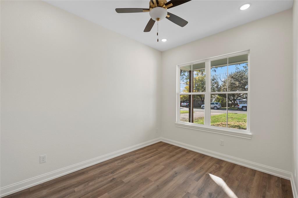 603 South Harrison Street West, TX 76691 - Photo 25 of 30 an empty room with wooden floor fan and windows