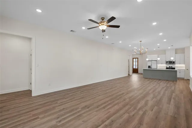 a view of a kitchen with a sink and wooden floor