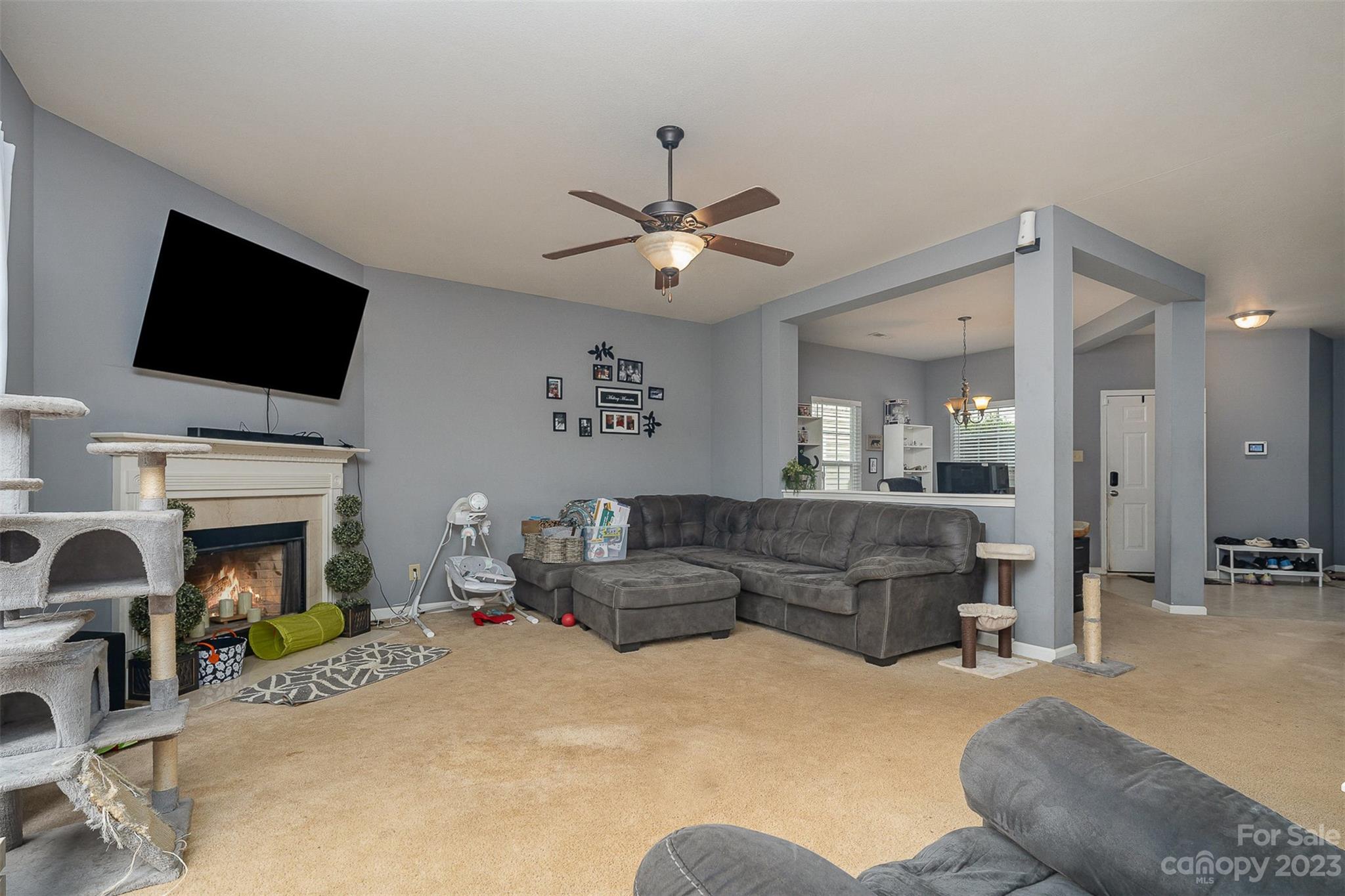 2070 Durand Road Fort Mill, SC 29715 - Photo 11 of 28 a living room with furniture a flat screen tv and a fireplace