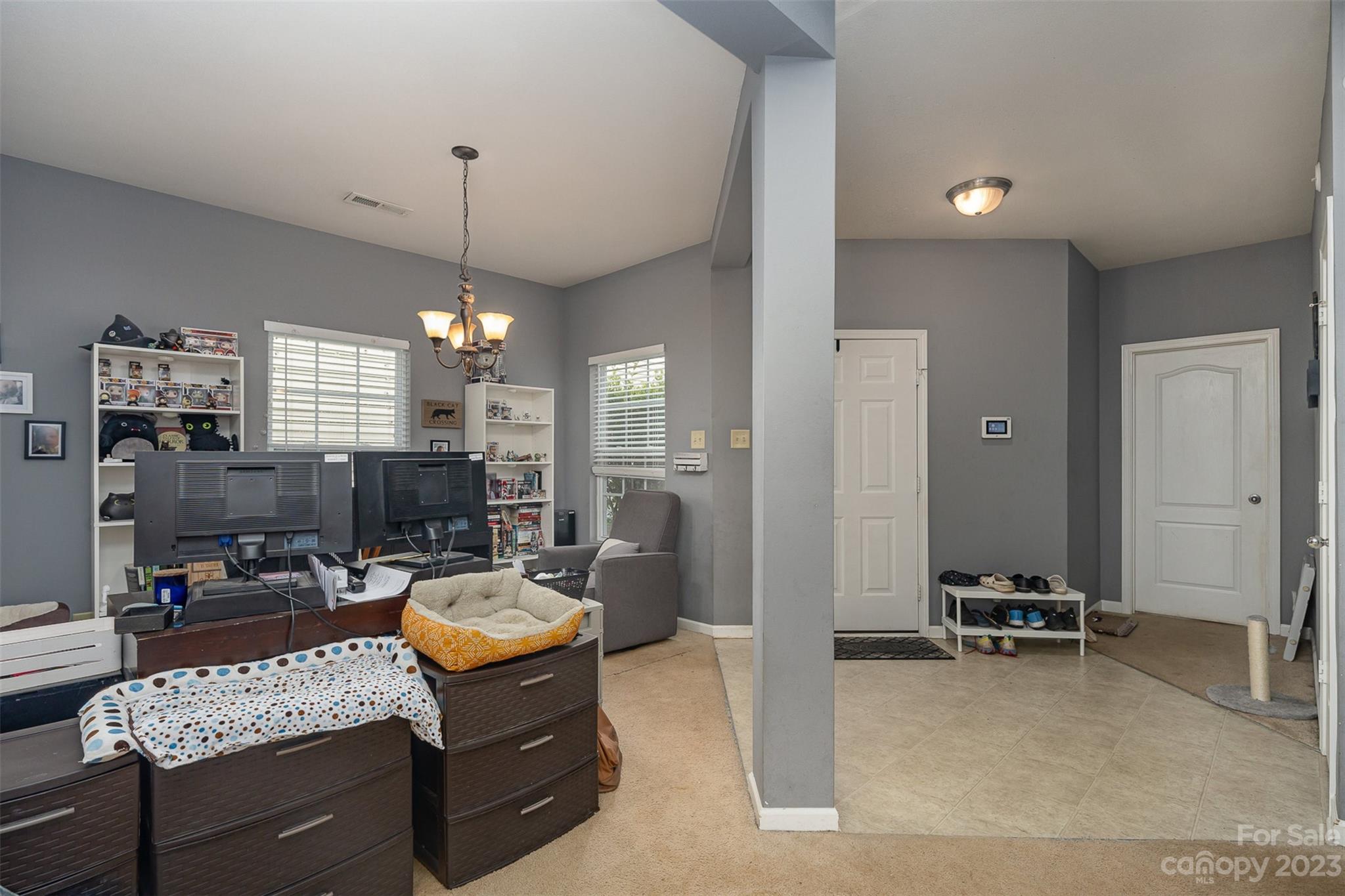 2070 Durand Road Fort Mill, SC 29715 - Photo 6 of 28 a living room with furniture a chandelier and a flat screen tv