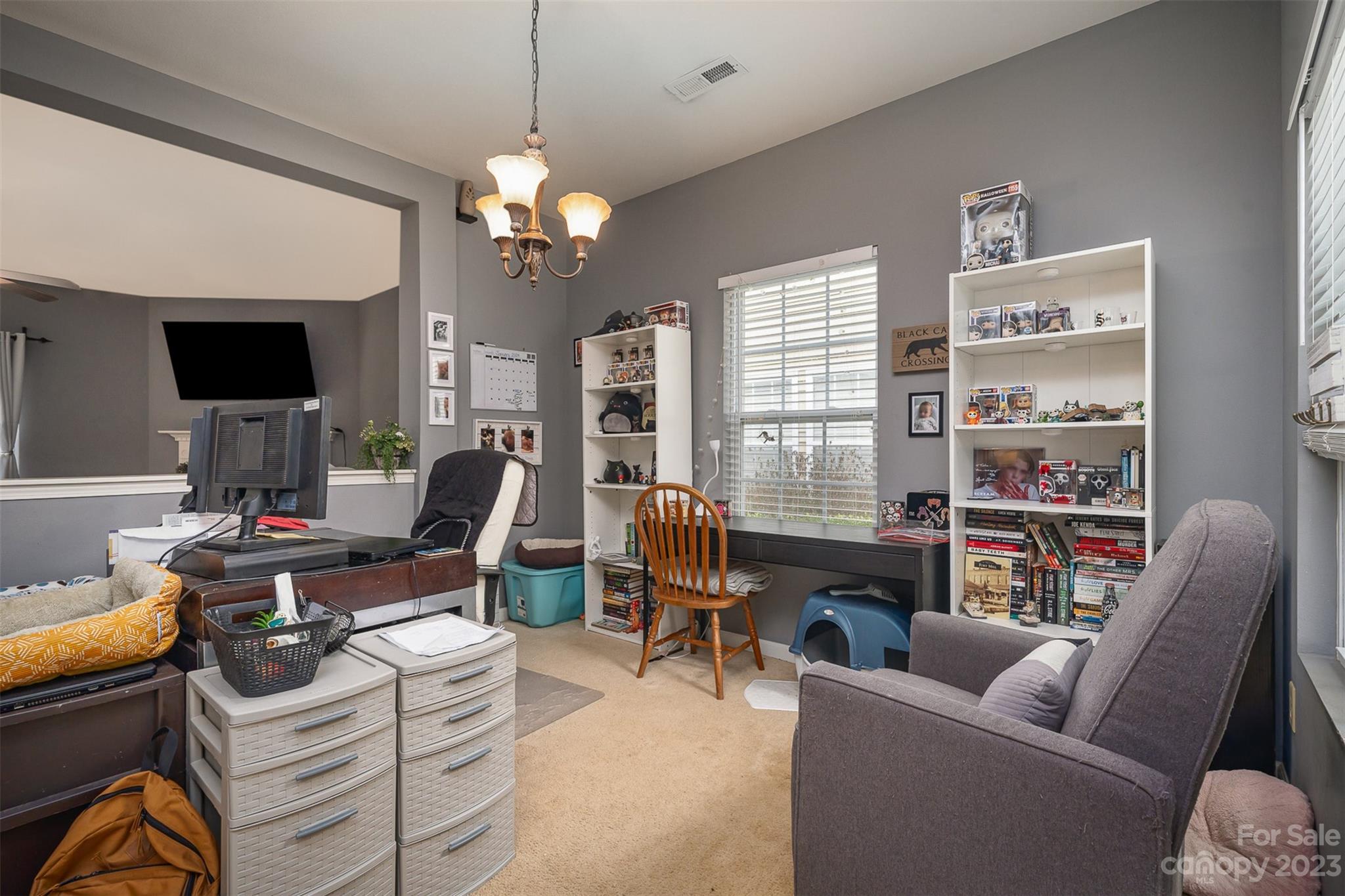 2070 Durand Road Fort Mill, SC 29715 - Photo 7 of 28 a living room with furniture a chandelier and a flat screen tv