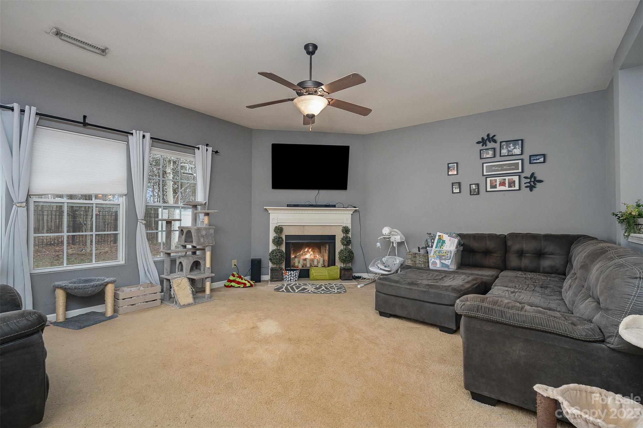2070 Durand Road Fort Mill, SC 29715 - Photo 10 of 28 a living room with furniture a fireplace and a flat screen tv