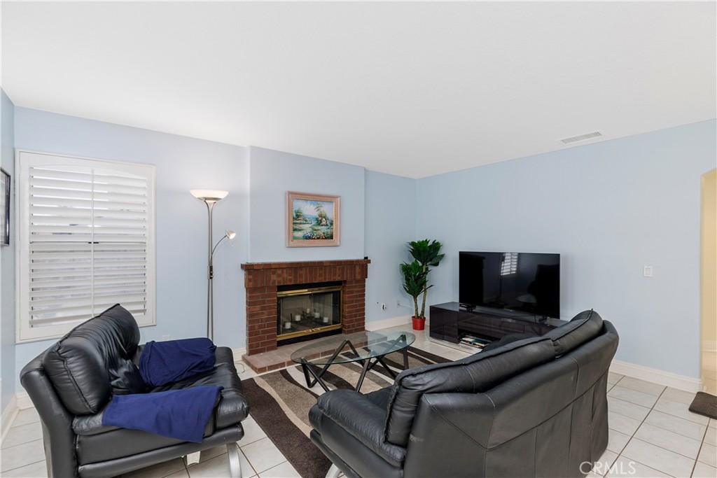 1874 Natalie Lane Riverside, CA 92506 - Photo 15 of 40 a living room with furniture a flat screen tv and a fireplace
