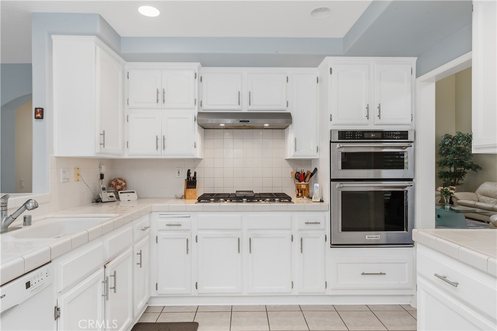 1874 Natalie Lane Riverside, CA 92506 - Photo 20 of 40 a kitchen with white cabinets and appliances