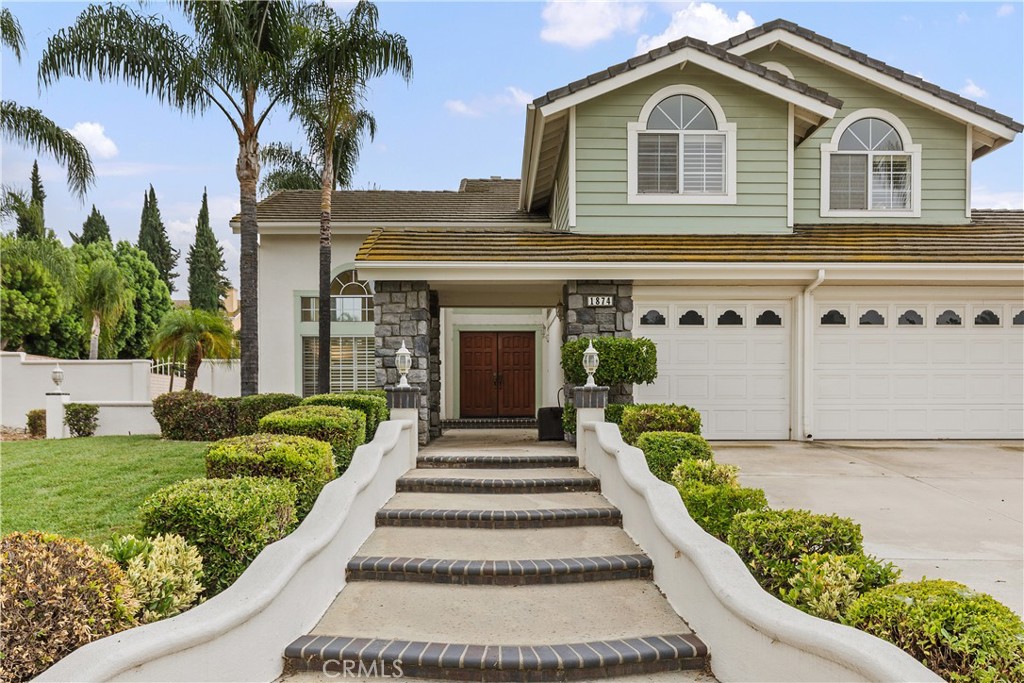 1874 Natalie Lane Riverside, CA 92506 - Photo 2 of 40 a front view of a house with a garden