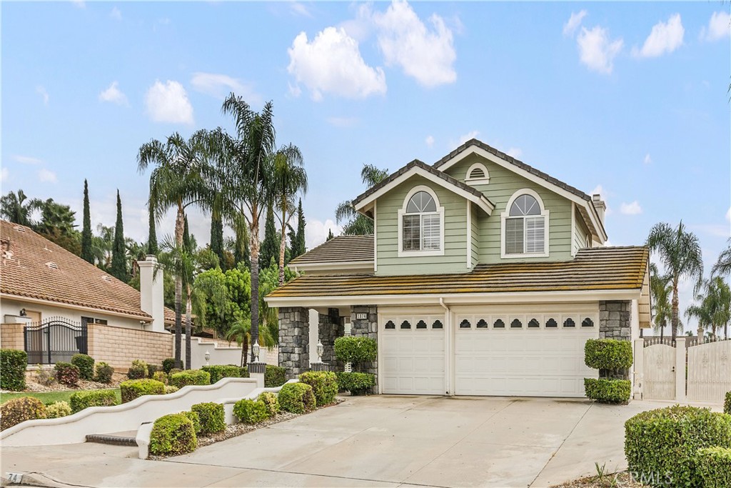 1874 Natalie Lane Riverside, CA 92506 - Photo 4 of 40 a view of a white house with a large windows and a yard