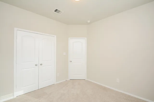 a view of backyard of house with wooden fence