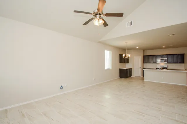 a view of kitchen with a sink cabinets and window