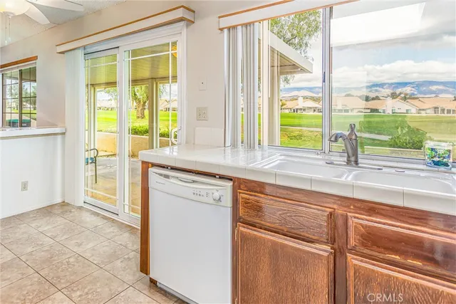 a kitchen with a sink and a large window