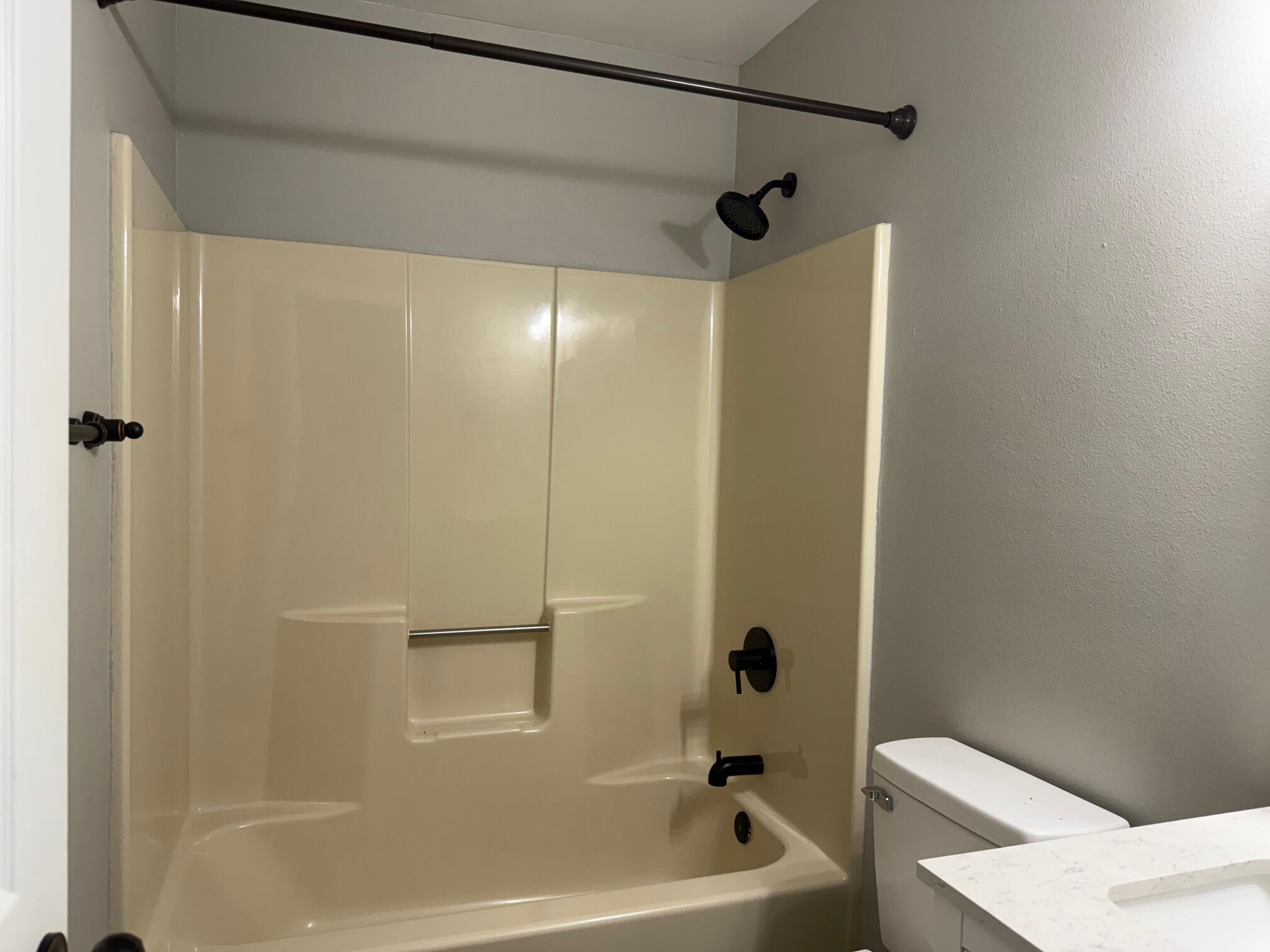 5809 Pinecrest Road Crestview, FL 32539 - Photo 11 of 14 a bathroom with a bathtub and a shower
