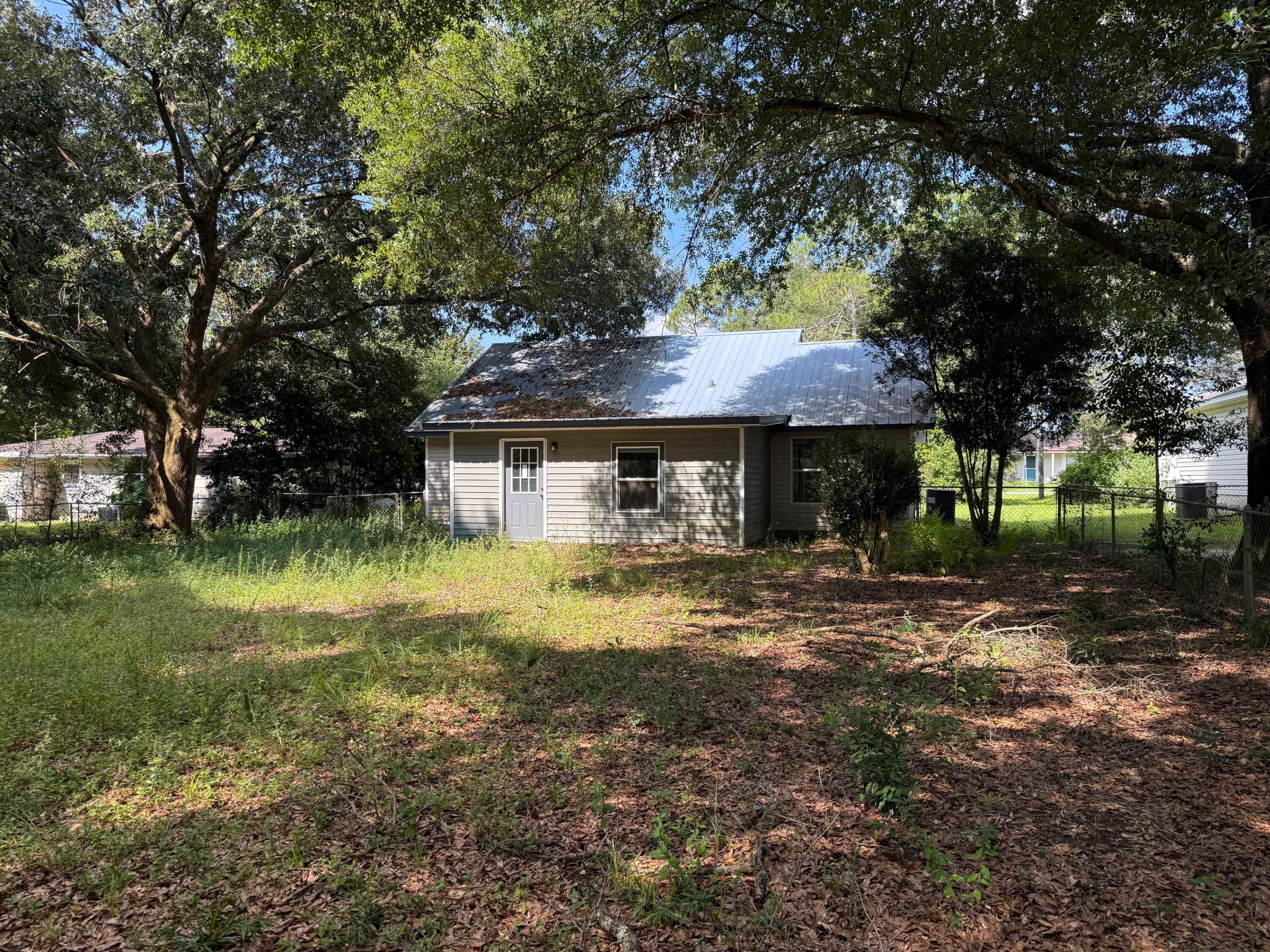 5809 Pinecrest Road Crestview, FL 32539 - Photo 14 of 14 a front view of a house with garden