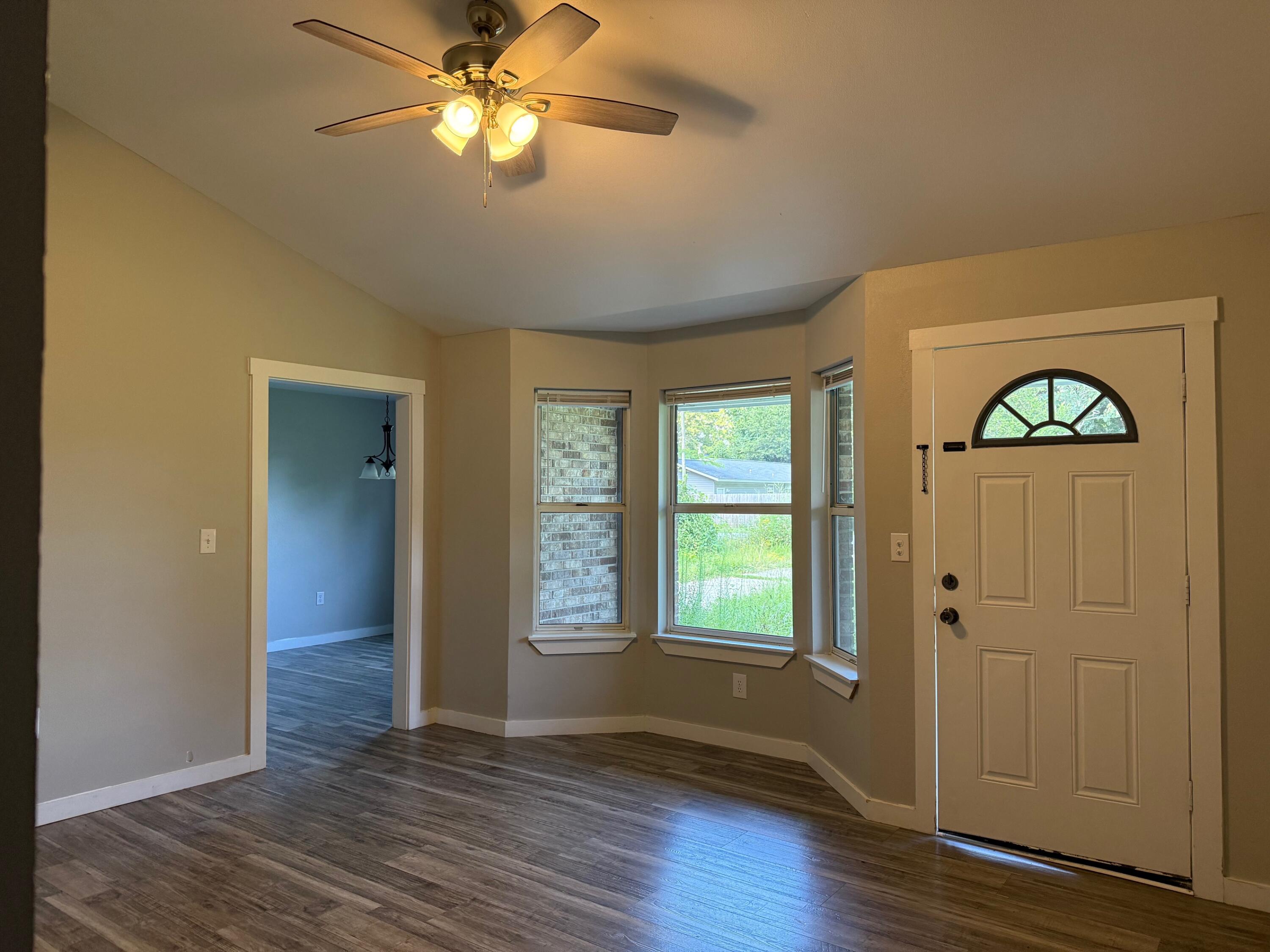 5809 Pinecrest Road Crestview, FL 32539 - Photo 7 of 14 wooden floor in an empty room with a window