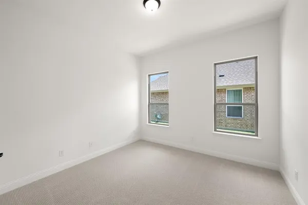 an empty room with windows and entrance