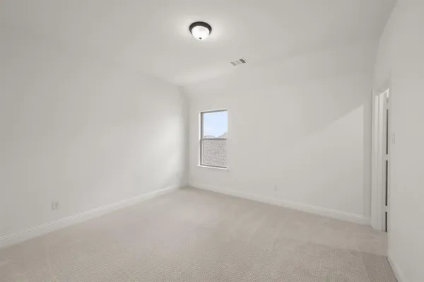 a view of an empty room and a window