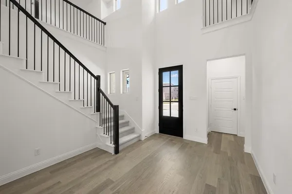 a view of entryway with wooden floor and stairs