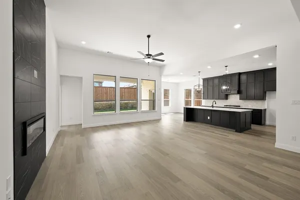 a view of kitchen with sink and refrigerator