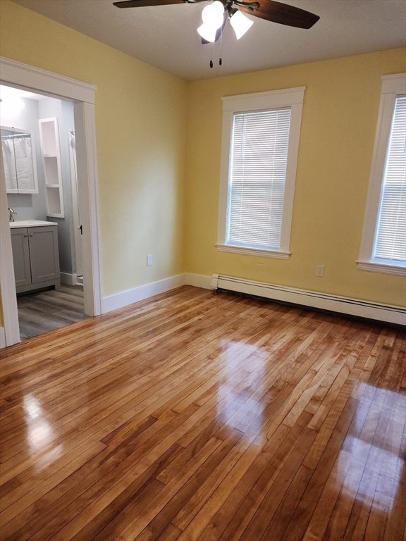 63 Fifth Avenue, Unit 1 Worcester, MA 01607 - Photo 10 of 13 a view of an empty room with wooden floor and a window
