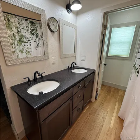 a bathroom with a double vanity sink and a mirror