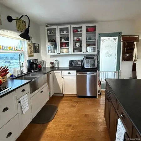 a kitchen with stainless steel appliances granite countertop a sink a stove and a refrigerator