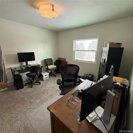 a work room with furniture and a window
