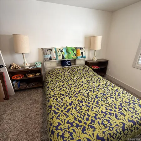a bedroom with a bed and lamp