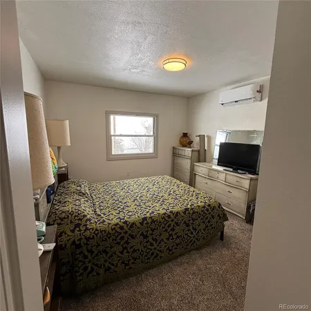 a bedroom with a bed and two windows