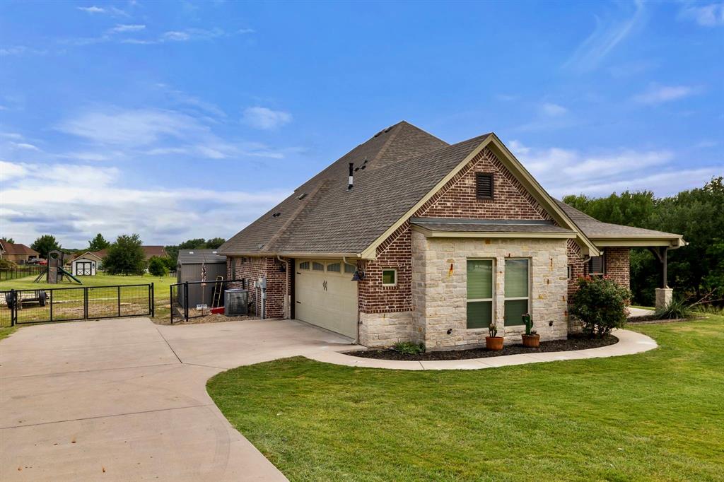 2103 Cash Point Court Granbury, TX 76049 - Photo 5 of 38 a front view of a house with a yard