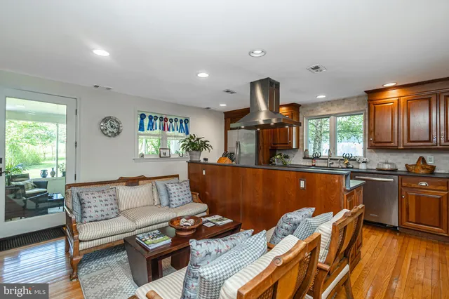 a kitchen with stainless steel appliances granite countertop a stove a sink dishwasher and a microwave oven with cabinets