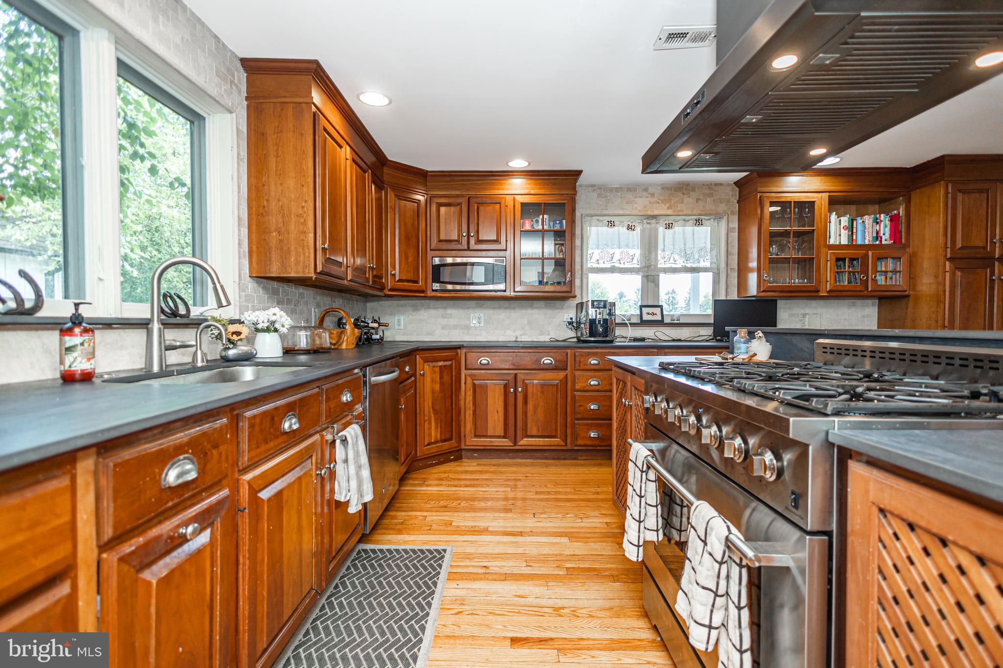 439 Brownsburg Road, Unit W Newtown, PA 18940 - Photo 20 of 68 a kitchen with stainless steel appliances granite countertop a stove a sink dishwasher and a microwave oven with cabinets
