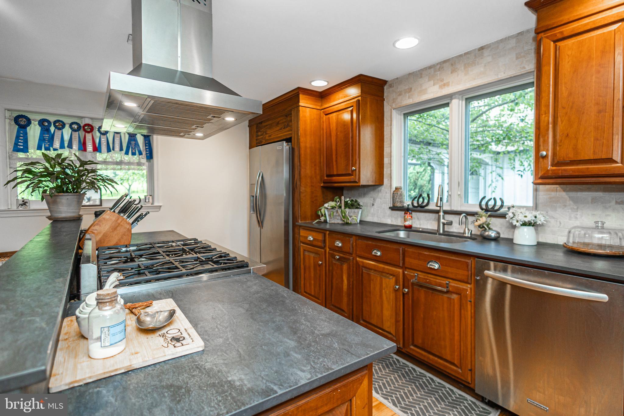 439 Brownsburg Road, Unit W Newtown, PA 18940 - Photo 22 of 68 a kitchen with stainless steel appliances granite countertop a sink stove and cabinets
