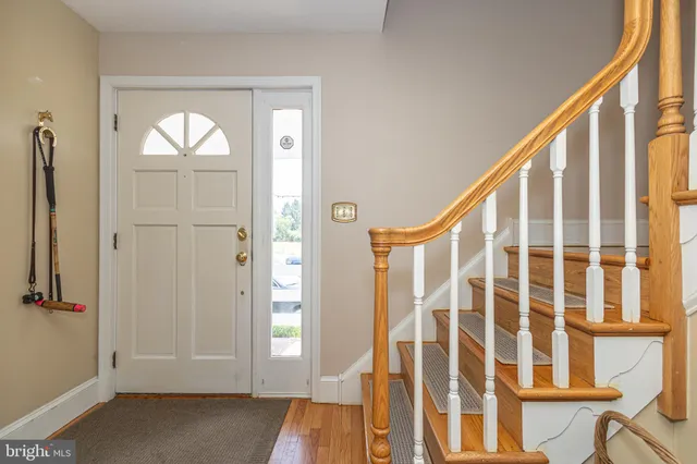 a living room with furniture and a book shelf