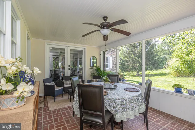 a bathroom with a granite countertop sink toilet and mirror