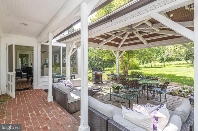 a backyard of a house with yard table and chairs