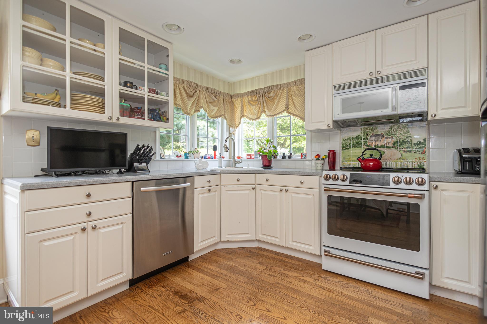 439 Brownsburg Road, Unit W Newtown, PA 18940 - Photo 48 of 68 a kitchen with stainless steel appliances granite countertop a stove a sink and a microwave