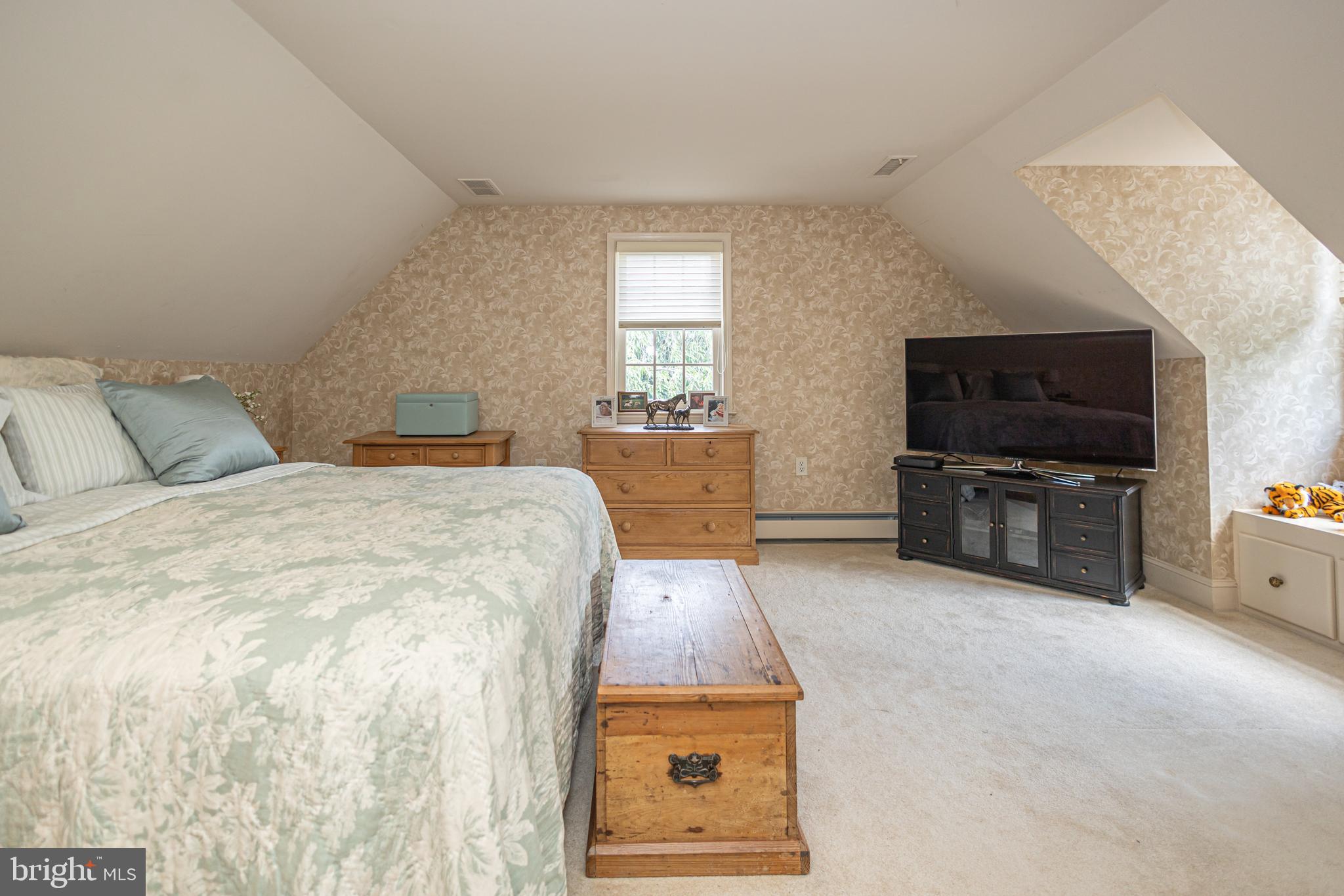 439 Brownsburg Road, Unit W Newtown, PA 18940 - Photo 53 of 68 a bedroom with a bed and flat tv screen on the dresser