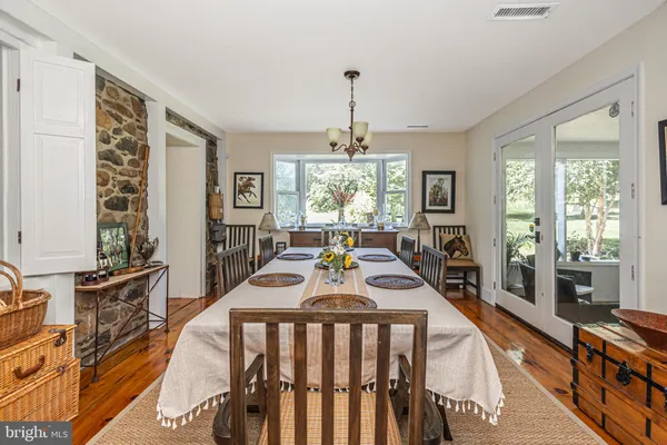 a dining room with furniture a chandelier and window