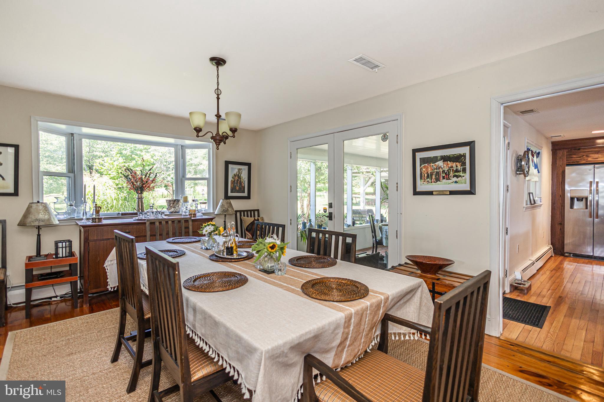 439 Brownsburg Road, Unit W Newtown, PA 18940 - Photo 9 of 68 a dining room with furniture a chandelier and window