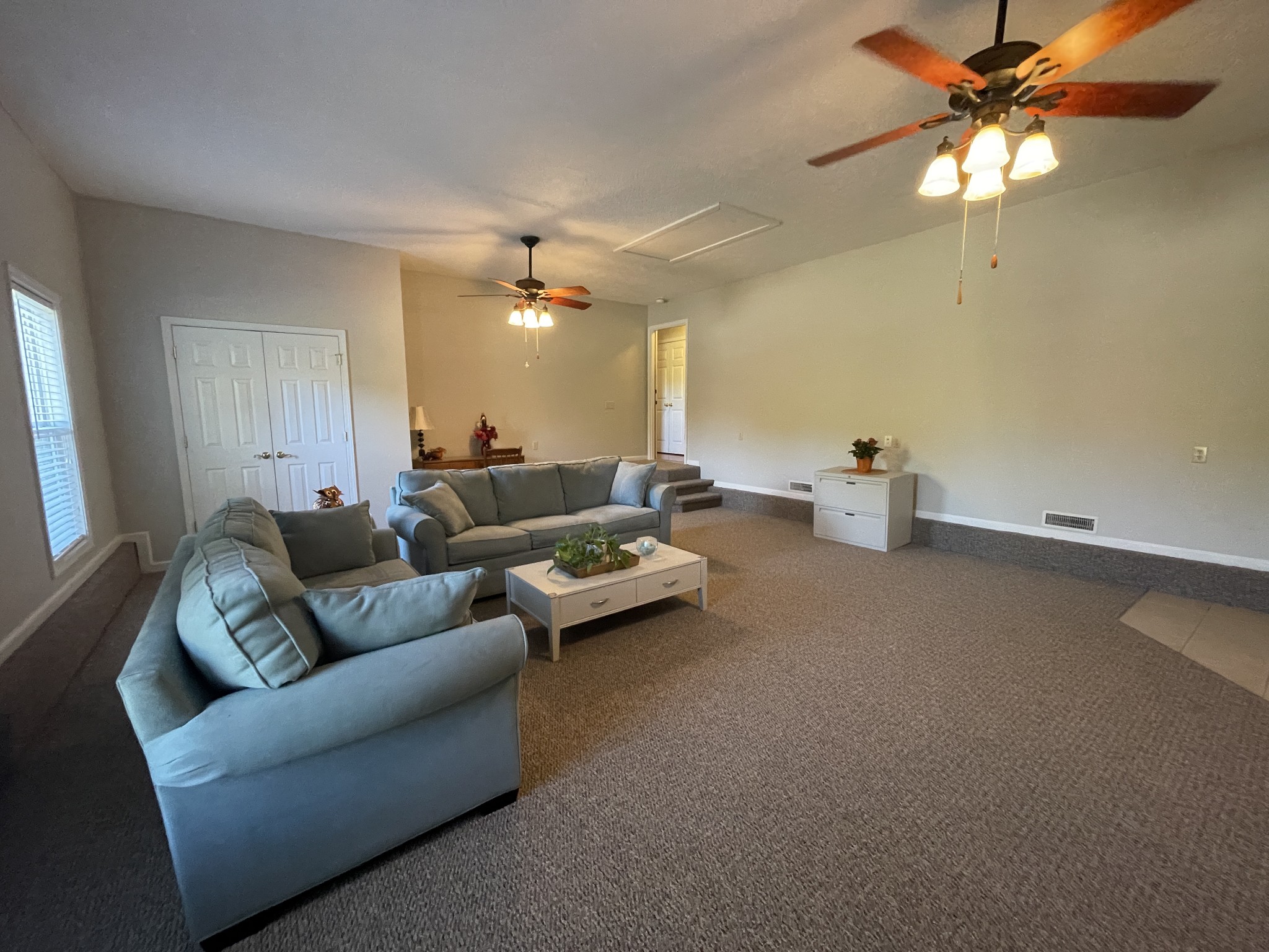 2946 Old Clarksville Sprgfld Road Adams, TN 37010 - Photo 11 of 24 a living room with furniture a chandelier and a ceiling fan