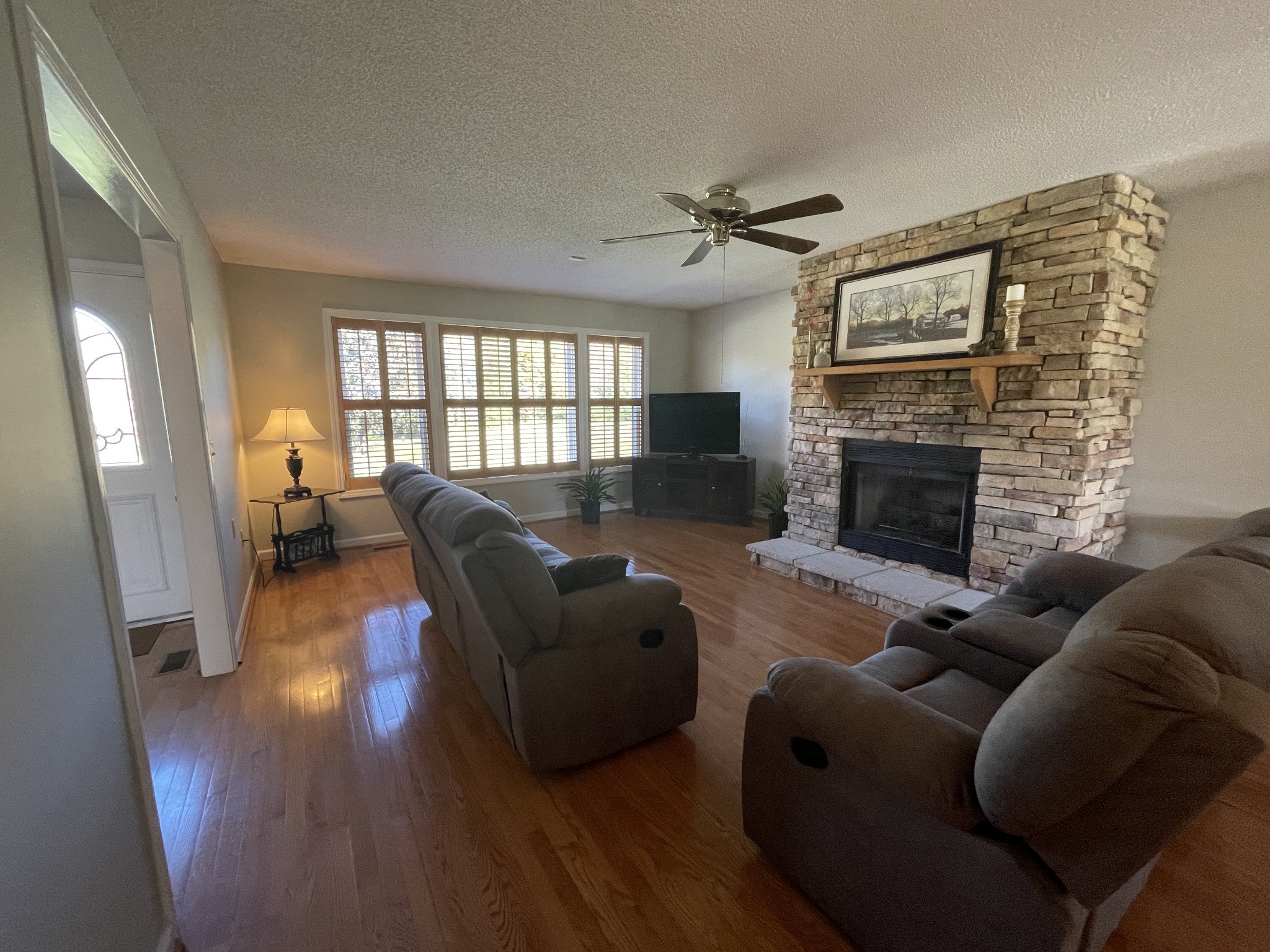 2946 Old Clarksville Sprgfld Road Adams, TN 37010 - Photo 13 of 24 a living room with furniture a large window and a fireplace