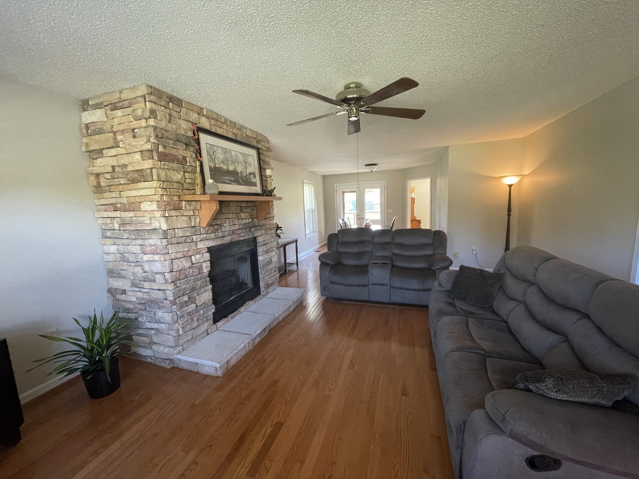 2946 Old Clarksville Sprgfld Road Adams, TN 37010 - Photo 14 of 24 a living room with furniture wooden floor and a fireplace