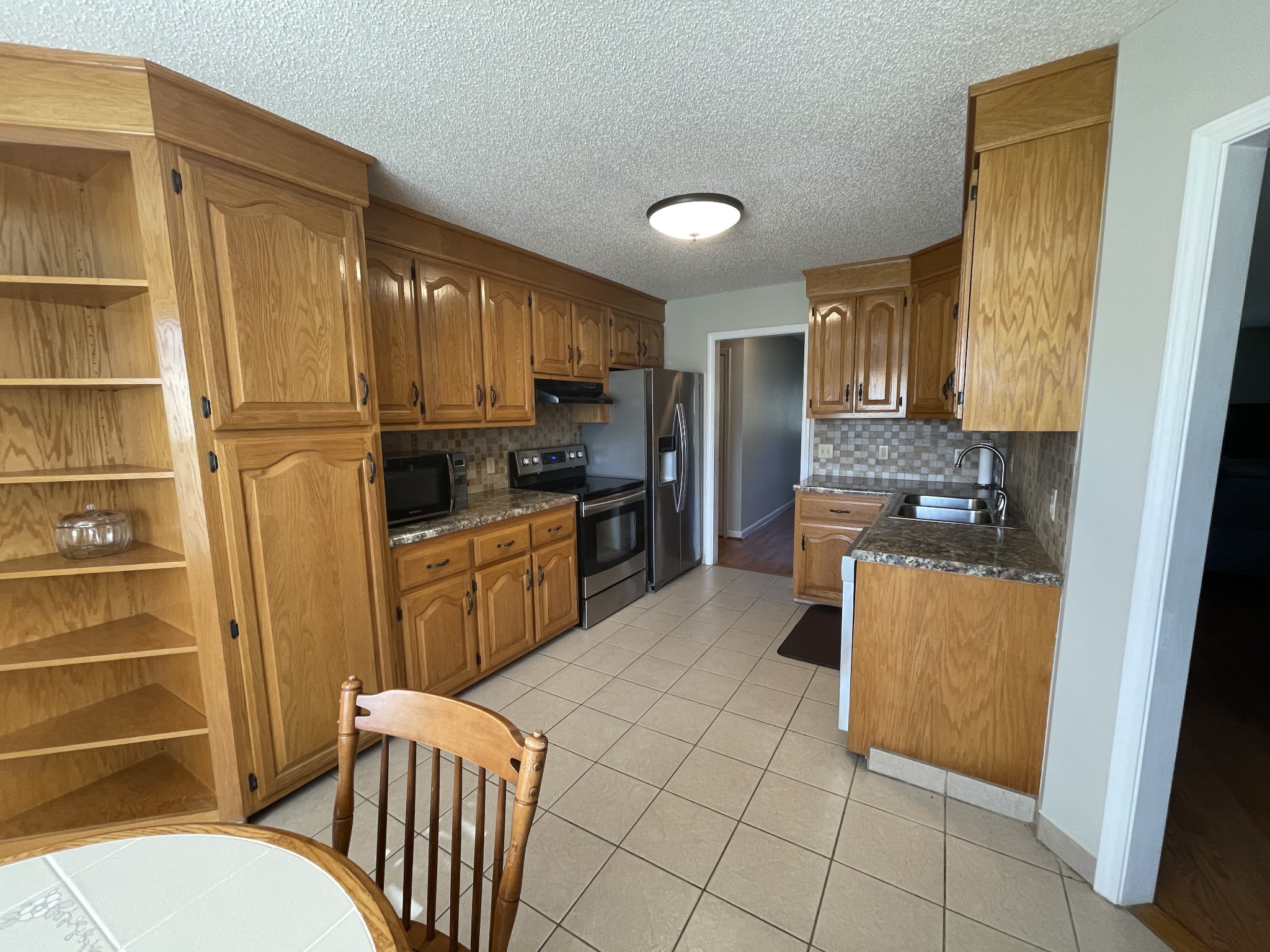 2946 Old Clarksville Sprgfld Road Adams, TN 37010 - Photo 16 of 24 a kitchen with stainless steel appliances a refrigerator sink and cabinets
