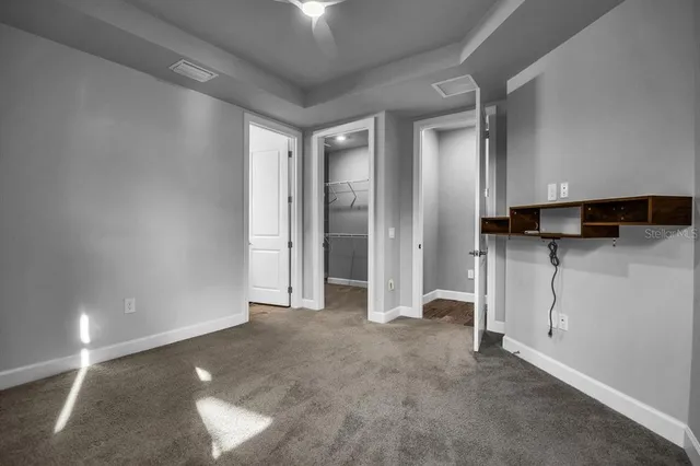 a view of a big room with air conditioner duct and materials on floor