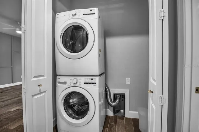 a front view of a house with a garden and palm tree