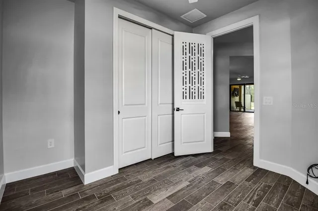 a large dining space with furniture a rug and wooden floor
