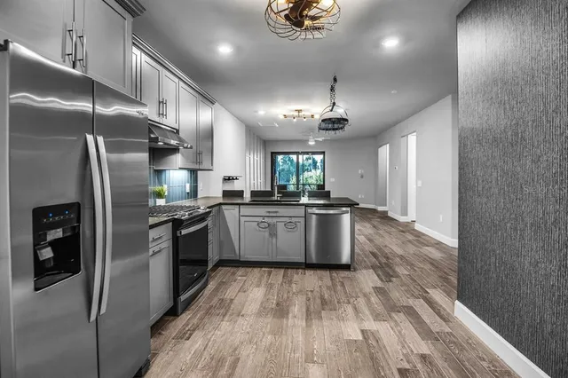 a bathroom with a sink toilet a mirror and shower