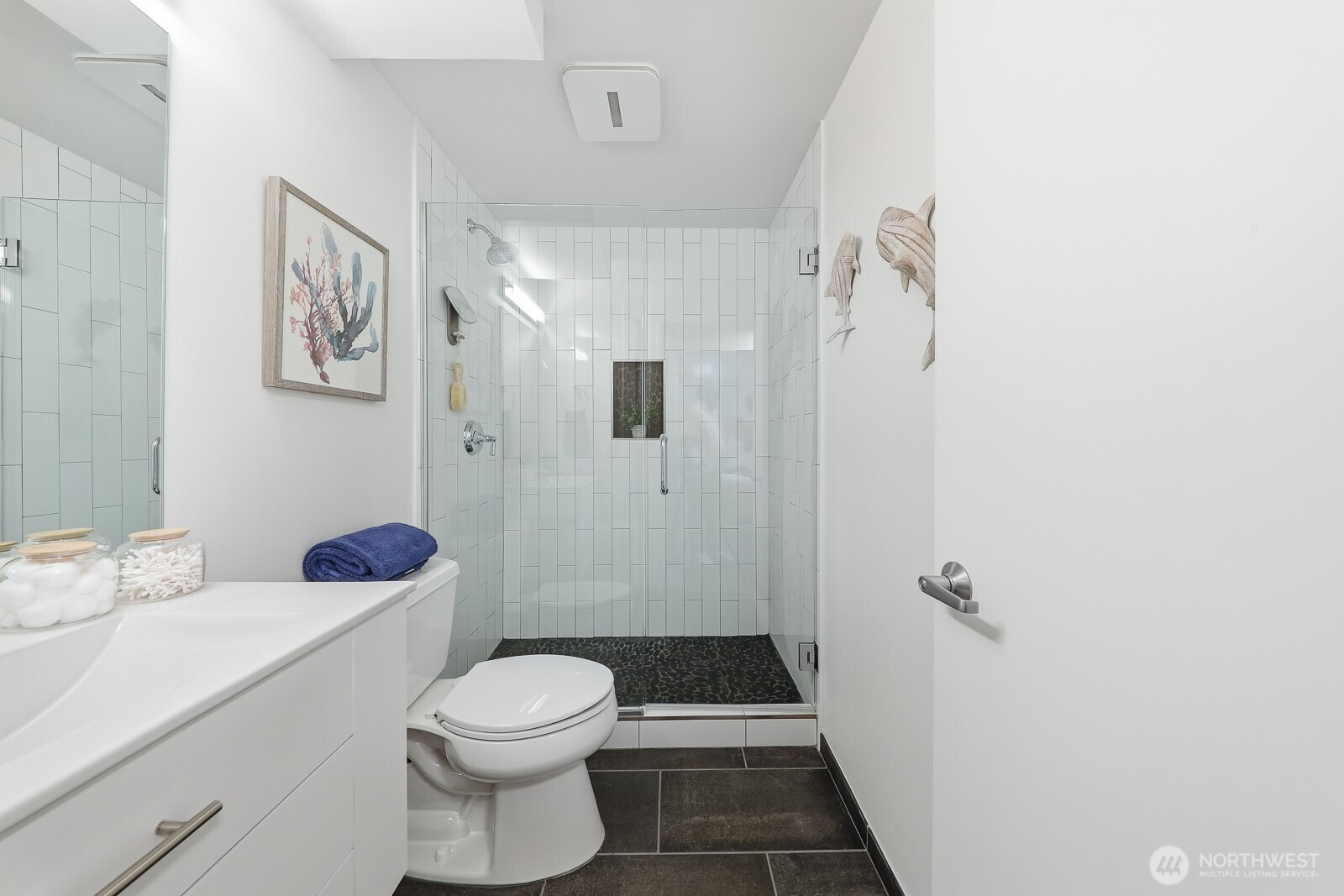 3401 Wallingford Avenue North, Unit 408 Seattle, WA 98103 - Photo 11 of 15 a bathroom with a sink a toilet and shower