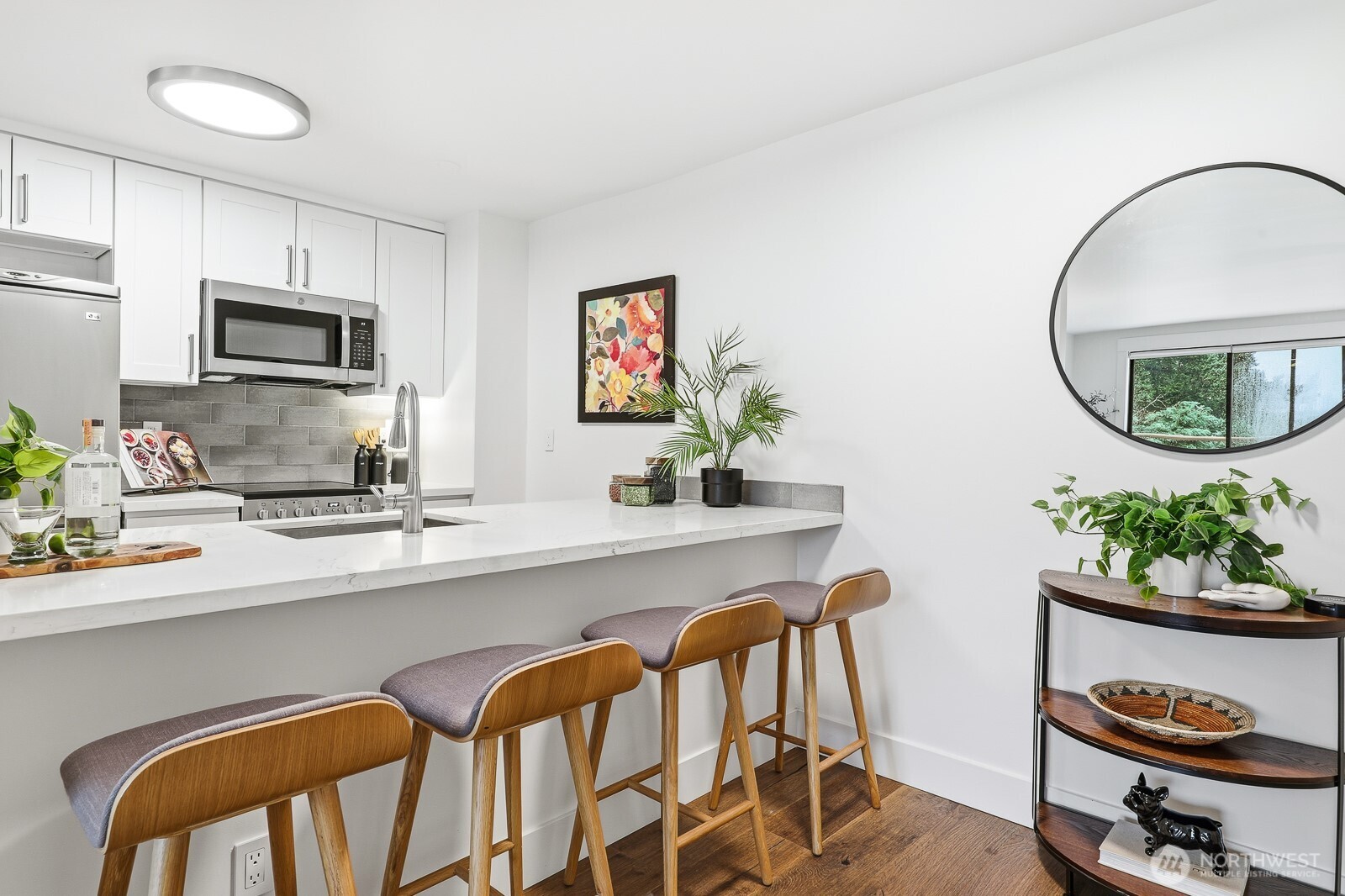 3401 Wallingford Avenue North, Unit 408 Seattle, WA 98103 - Photo 4 of 15 a kitchen with a dining table and chairs