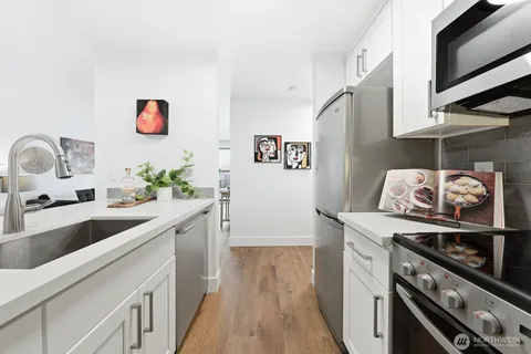 a kitchen with stainless steel appliances granite countertop a sink and a stove