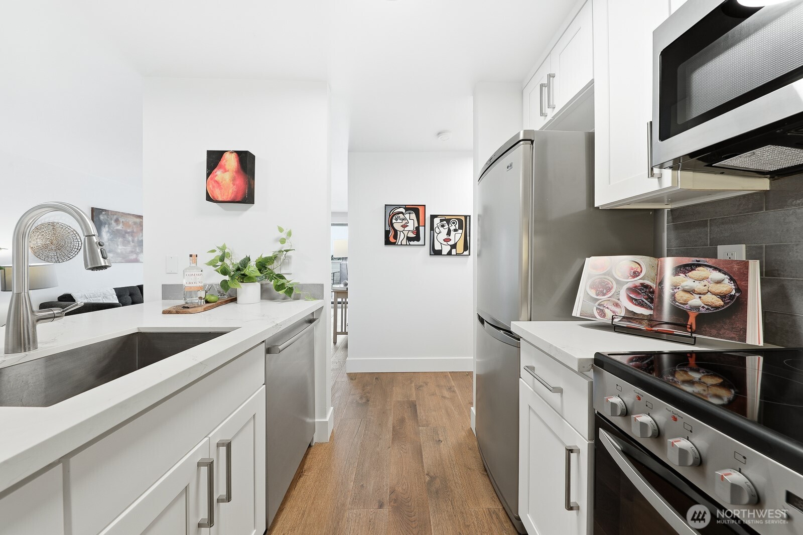 3401 Wallingford Avenue North, Unit 408 Seattle, WA 98103 - Photo 6 of 15 a kitchen with stainless steel appliances granite countertop a sink and a stove