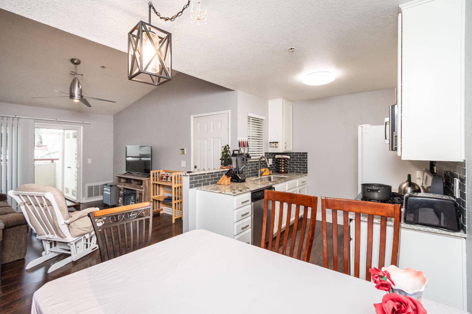 8020 Walerga Road, Unit 1238 Antelope, CA 95843 - Photo 15 of 22 a kitchen with stainless steel appliances a sink dishwasher a dining table chairs with wooden floor